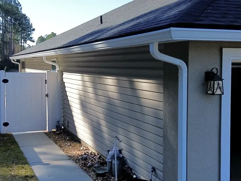 White 6 inch seamless gutter and downspout installed by LePierre Roofing