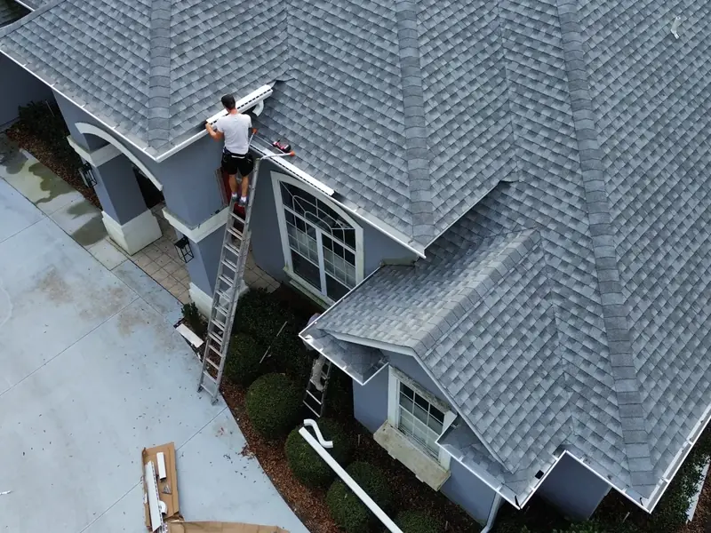 LePierre Roofing crew installing seamless gutters in Fernandina Beach