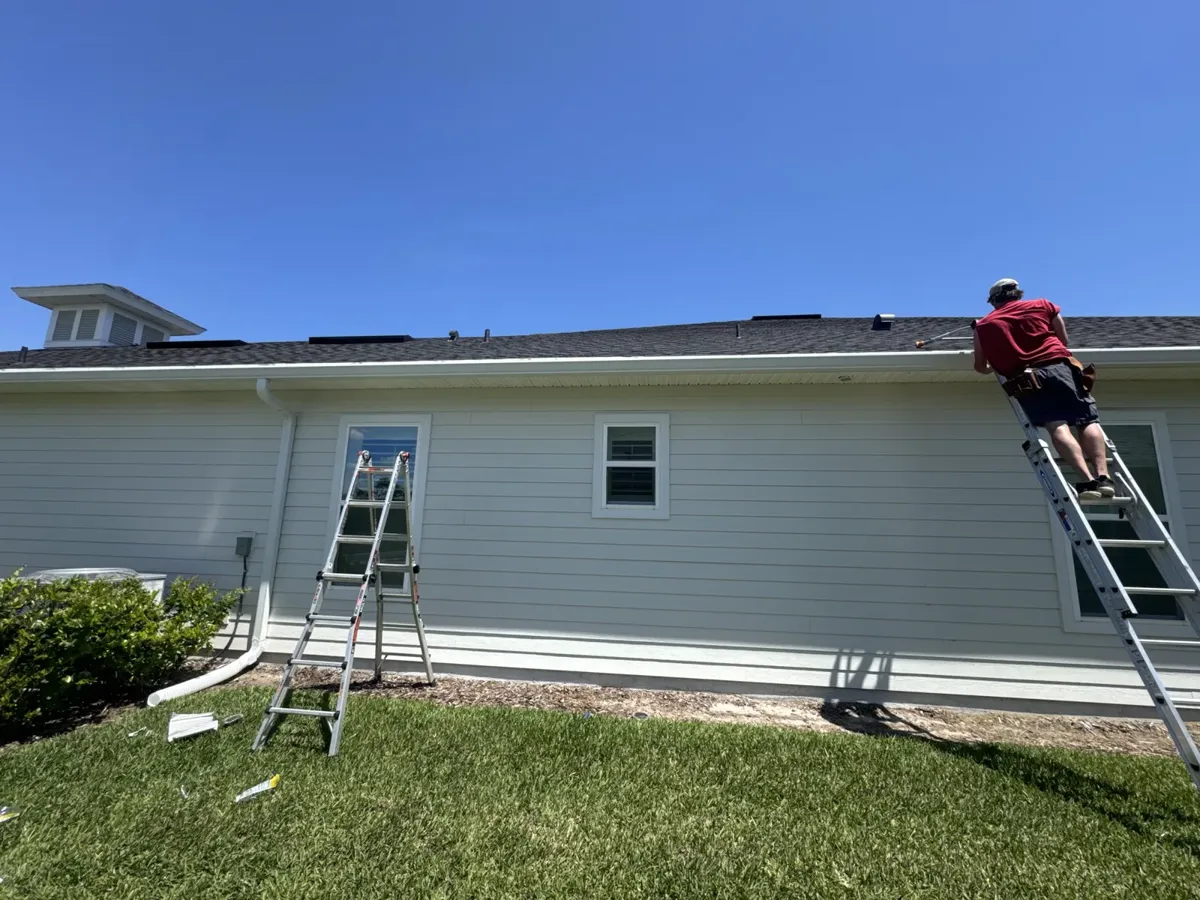 LePierre Roofing Gutter Division crew installing gutters along a single story home