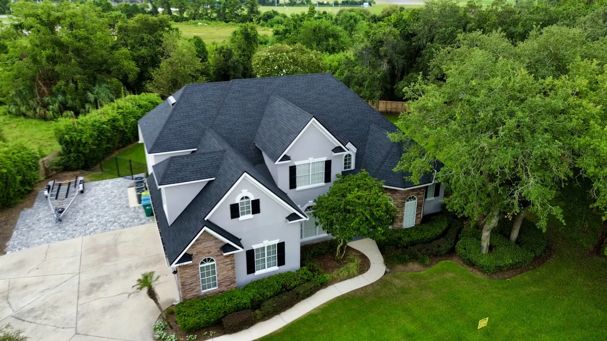 Aerial view of a new LePierre Roofing shingle roof on a Nassau County home